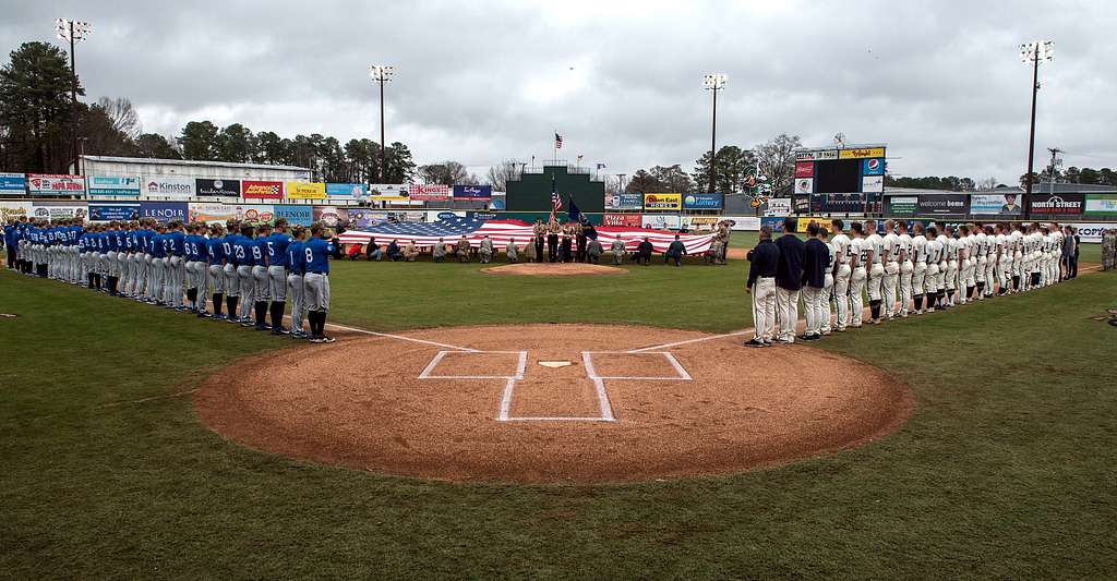 Naval Academy shortstop Michael Coritz throws to Naval Academy first  baseman Ben Lowe Feb. 24, 2018, during the Freedom Classic baseball  tournament at Grainger Stadium in Kinston, North Carolina. Navy took games