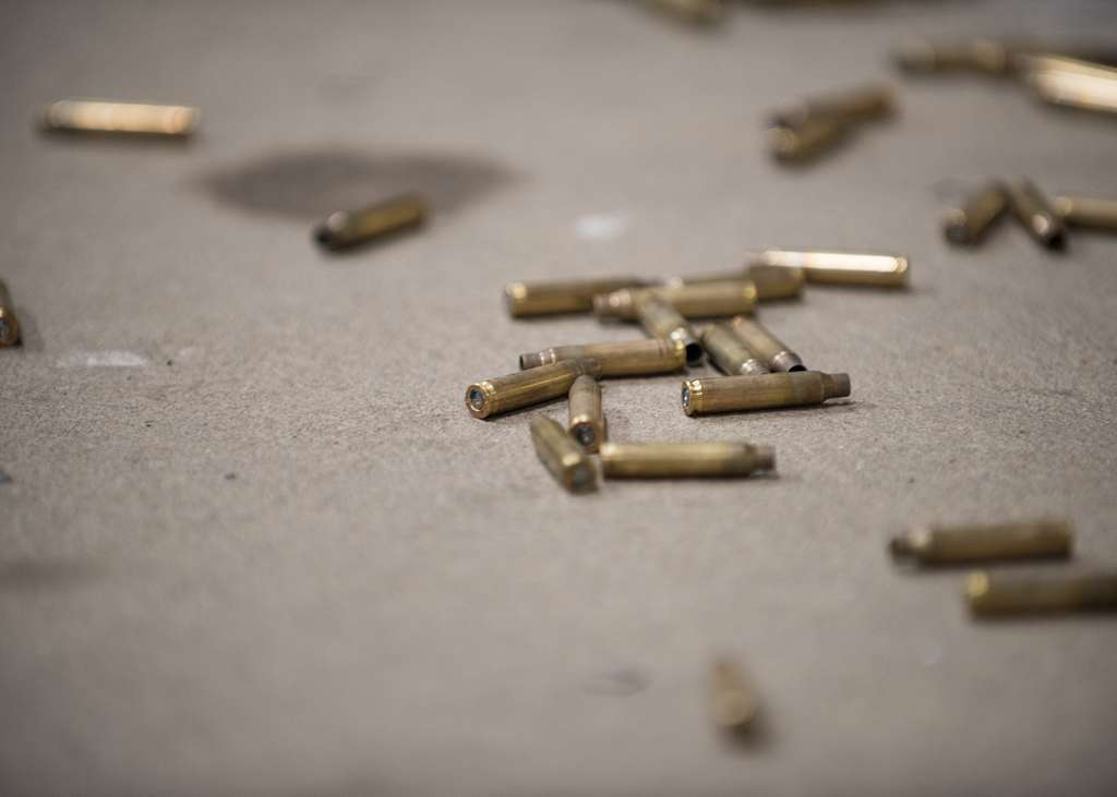 Spent shell cases sit on the floor after being ejected - NARA