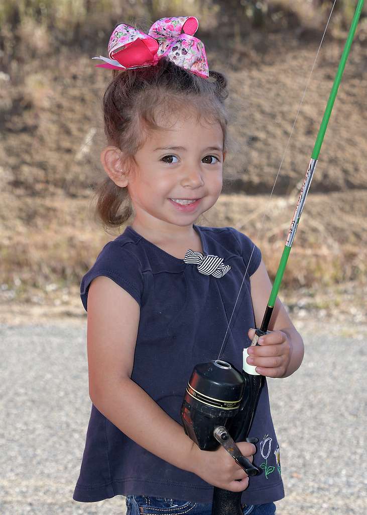 Three year old Zara grins as she accepts a fishing - PICRYL - Public Domain  Media Search Engine Public Domain Search