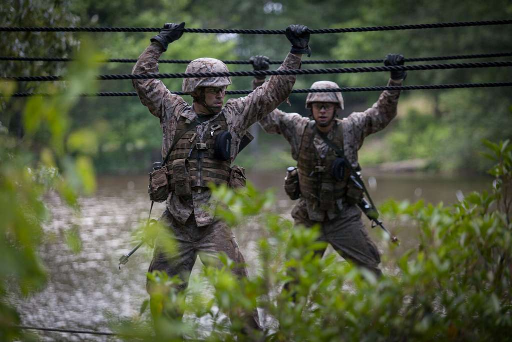 Officer candidates cross a two-rope bridge during the - NARA