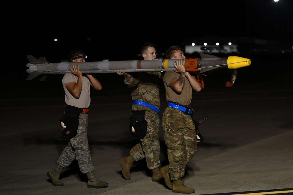 A Weapons Load Crew Assigned To The 4th Fighter Generation Squadron