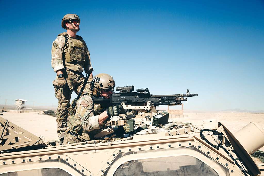 Two Soldiers from Task Force 3330, 3rd Special Forces Group (Airborne),  teach a class on how to properly remove MOPP (Mission-Oriented Protective  Posture) gear in the event of a simulated CBRN (Chemical