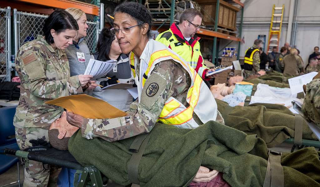 Lt Col. Cyril Arrington helps triage patients during - PICRYL - Public ...