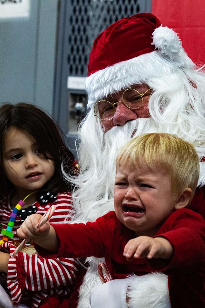 A child meets Santa Claus during a holiday event at - NARA & DVIDS ...