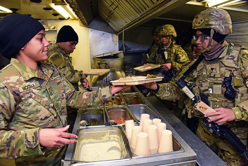 A Member Of Kitchen Patrol Serves Meals In The Dining 5afe7f 1024 