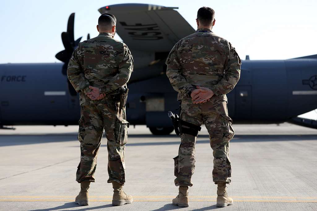 Command Sgt. Maj. John Hicks, right, Senior Enlisted Noncommissioned  Officer, Al Asad Air Base and 42nd Regional Support Group, New Jersey  National Guard, presents a coin to the Task Force Vikings outgoing