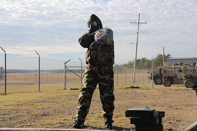 Two Soldiers from Task Force 3330, 3rd Special Forces Group (Airborne),  teach a class on how to properly remove MOPP (Mission-Oriented Protective  Posture) gear in the event of a simulated CBRN (Chemical