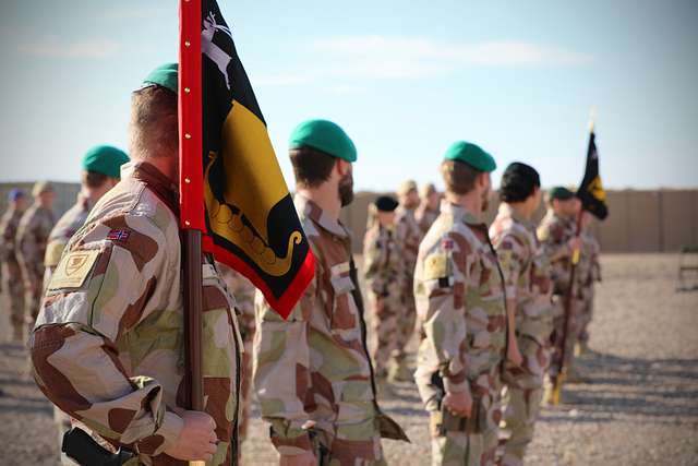 Command Sgt. Maj. John Hicks, right, Senior Enlisted Noncommissioned  Officer, Al Asad Air Base and 42nd Regional Support Group, New Jersey  National Guard, presents a coin to the Task Force Vikings outgoing