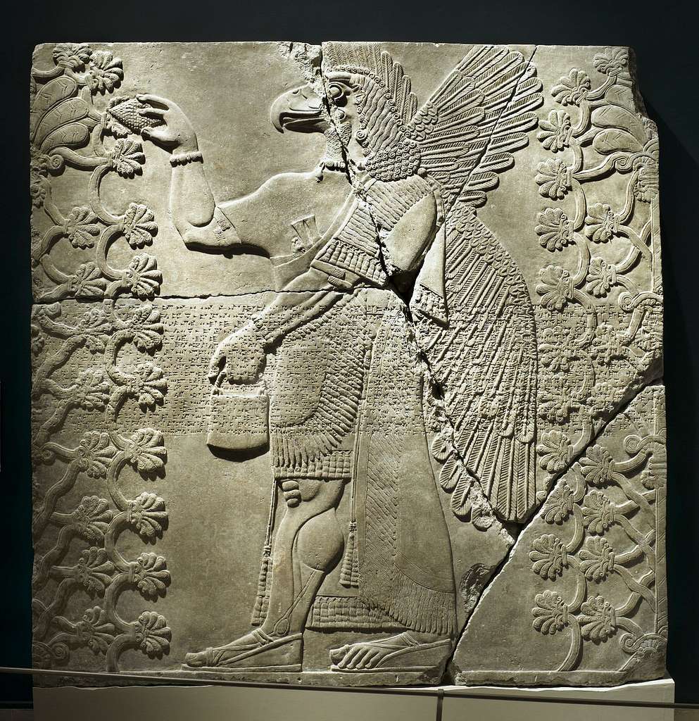 Assyrian Relief Of Eagle Headed Winged Figure Standing Between Two