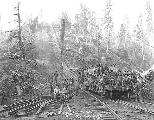 Logging crew and flat car at bottom of inclined railroad track, Saginaw ...