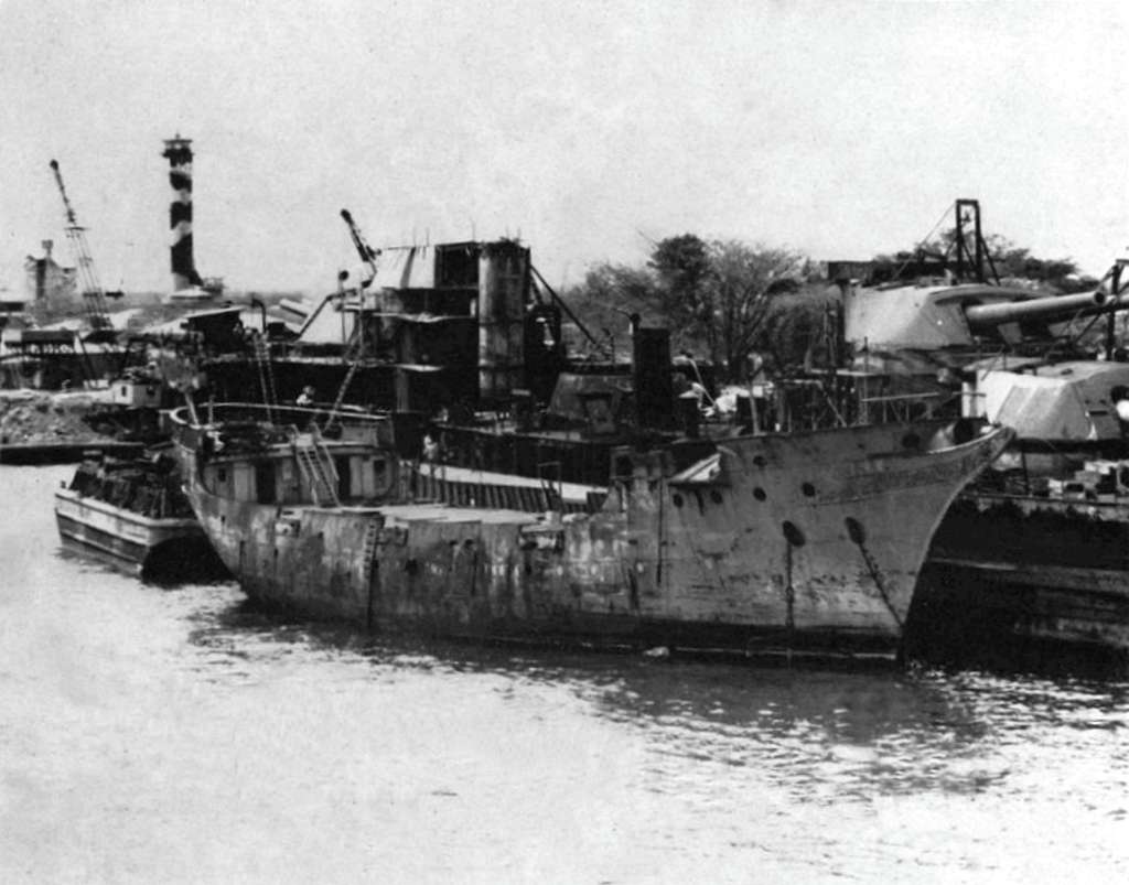 U.S. Navy sludge removal barge YSR-42 alongside of USS Oklahoma (BB-37 ...