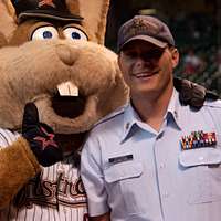 Service members take photos with Staley Da Bear, the Chicago Bears mascot  during the Chicago Bears Salute to Service game Nov. 27 at Soldier Field,  in Chicago. Nearly 100 personnel from all services participated in the pre- game and halftime show