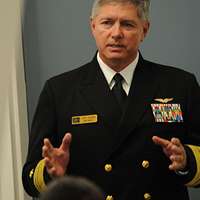 Informal full-length portrait of the CHIEF of Naval Operations, Admiral  Jeremy M. Boorda, USN, in dress white formal uniform. Photograph was taken  on the first floor of his official residence. (Exact date