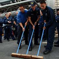 Offensive Tackle for the National Football League (NFL) San Diego Chargers,  Leander Jordan (75), signs an autograph for Aviation Electrician's Mate 3rd  Class Jerimy Holt during a visit aboard USS Ronald Reagan (