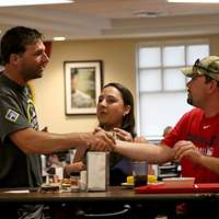 Jeff Francoeur, a player for the Atlanta Braves signs an autograph for a  military family member during a luncheon at Fort Bragg, N.C., July 3, 2016.  The event is a part of