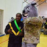 Illinois Army National Guard 2nd Lt. Zachary White, of Chicago, takes a  photo with Staley Da Bear, the Chicago Bears mascot during the Chicago Bears  Salute to Service game Nov. 27 at