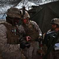 U.S. Army Spc. Bryan Hergesell, left, talks with Sgt. - PICRYL