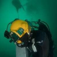 US Navy Engineman 2nd Class Anthony Bartelli (right) holds an