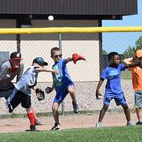 CAMP FOSTER, Okinawa, Japan – A child practices batting at a youth baseball  clinic July 29 aboard Camp Foster, Okinawa, Japan. The baseball clinic  hosted four different stations: hitting, running, catching and