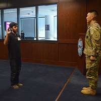 Capt. Eugene Lee, commander, Phoenix West Recruiting Center, enjoys a joke  with Jaron Brown, wide receiver, Arizona Cardinals, during the 8th 'Pro vs  G.I. Joe' video game competition, where recruiters competed against