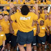 Offensive Tackle for the National Football League (NFL) San Diego Chargers,  Leander Jordan (75), signs an autograph for Aviation Electrician's Mate 3rd  Class Jerimy Holt during a visit aboard USS Ronald Reagan (