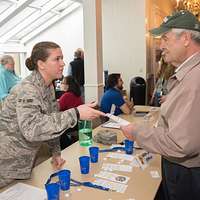 Miami Dolphins Linebacker Derek Rogers presents 100 tickets to Brigadier  General (BGEN) Charles E. Stenner, USAF