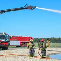 A firefighter operates a water hose during the Major Accident